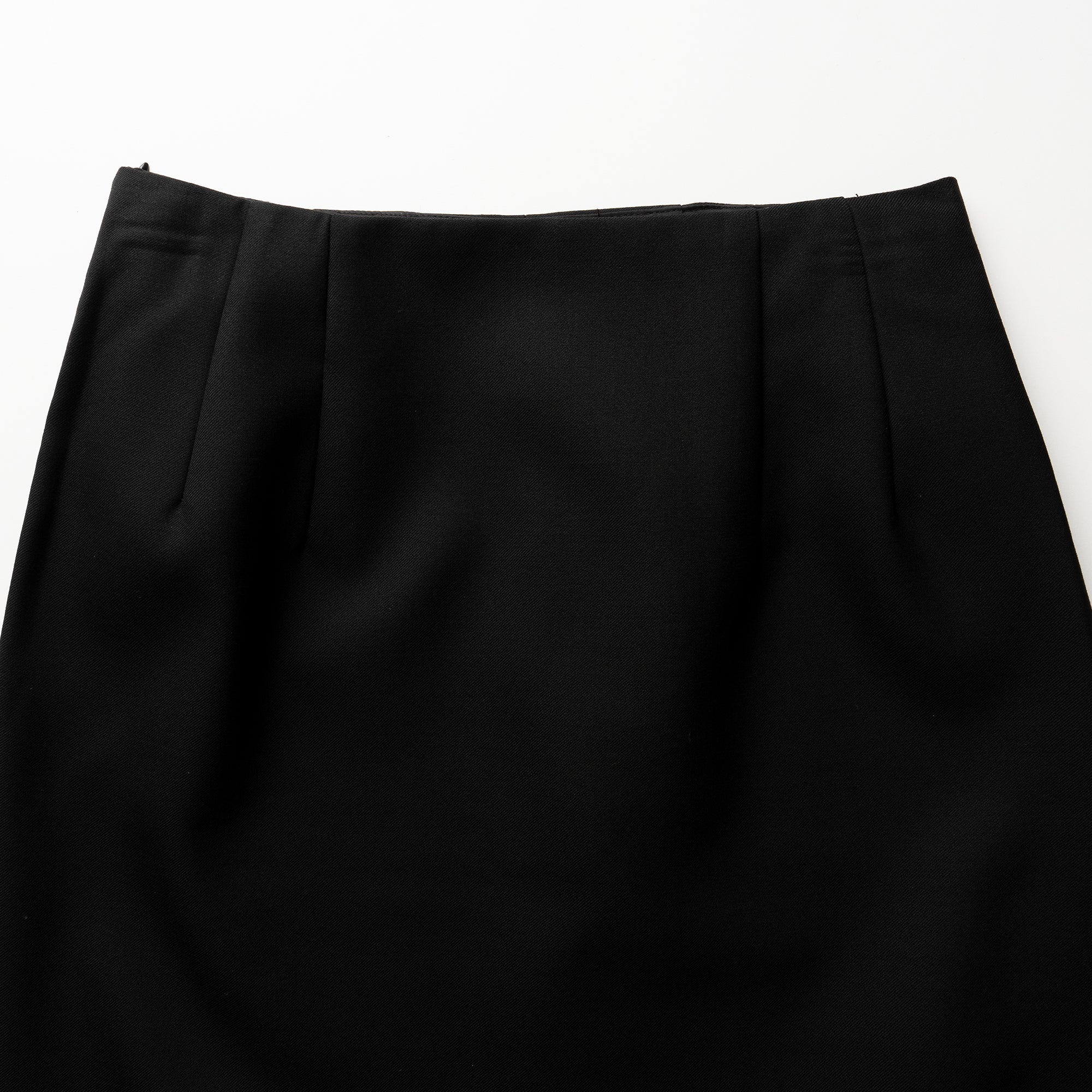 Close-up of a black skirt on a white background
