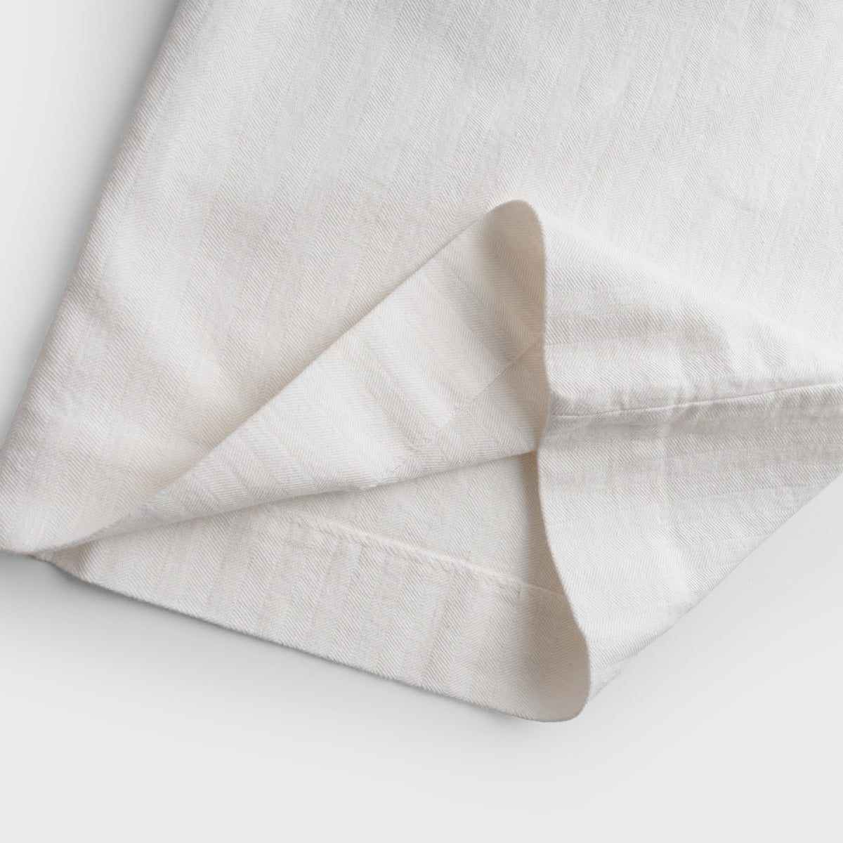 White pant leg on a light gray background
