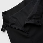 Close-up of a black skirt with a belt on a light gray background