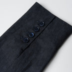 Navy linen fabric with buttons on a light gray background