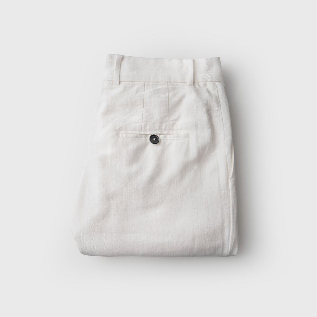 Folded white  pants on a white background