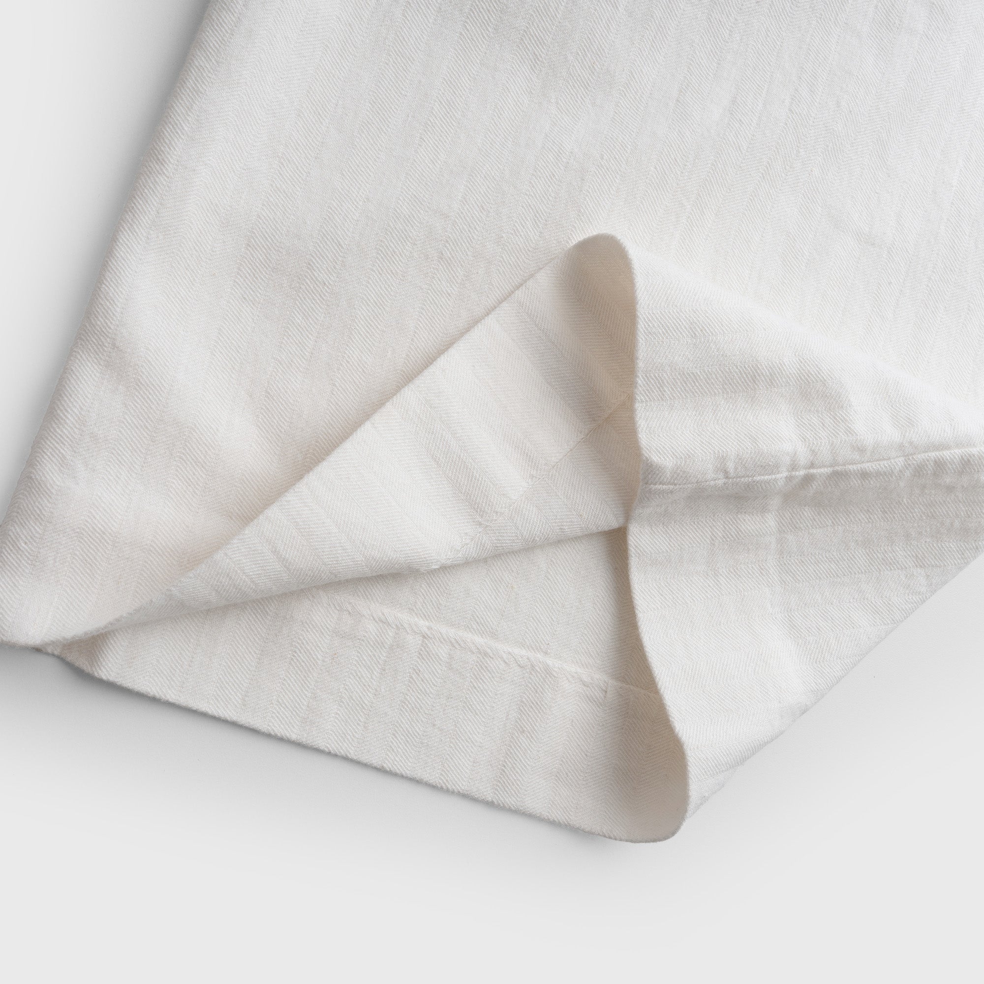 White pant leg on a light gray background