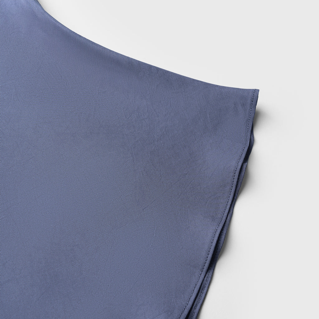 Blue fabric folded on a light gray background