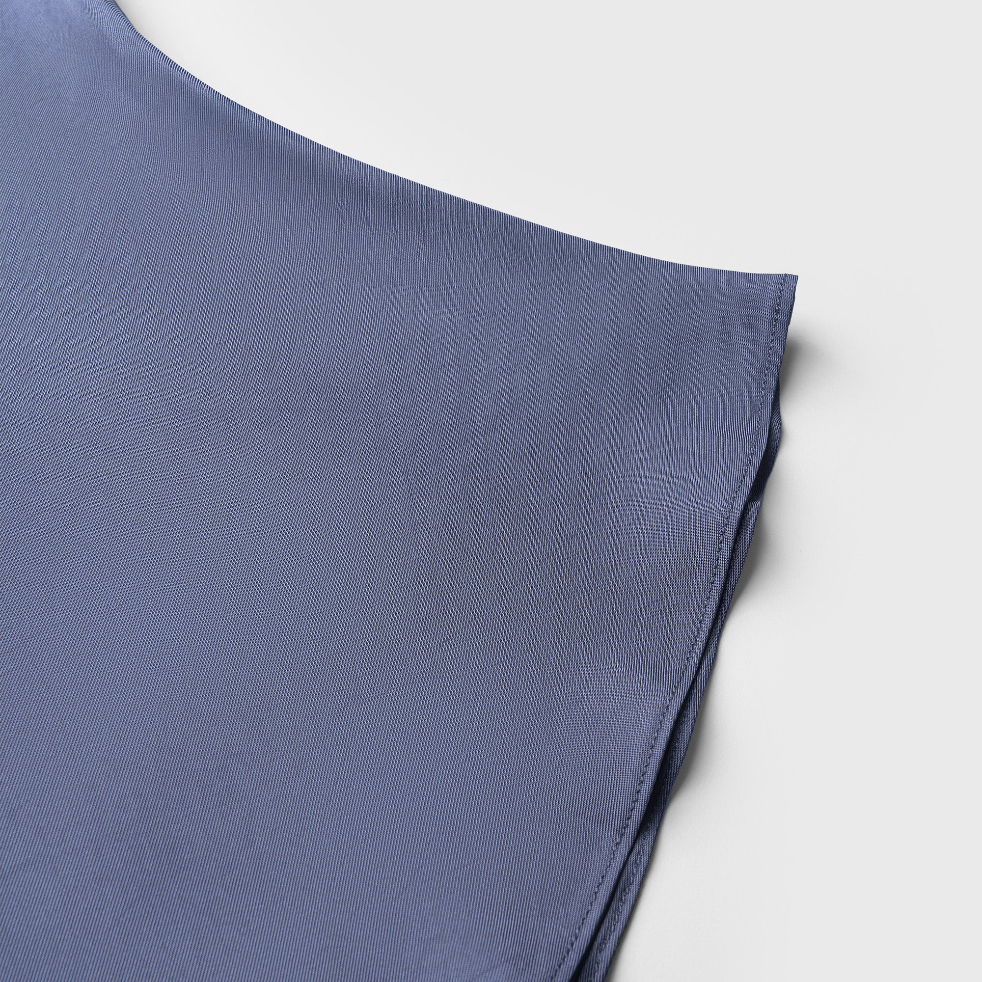 Blue fabric folded on a light gray background