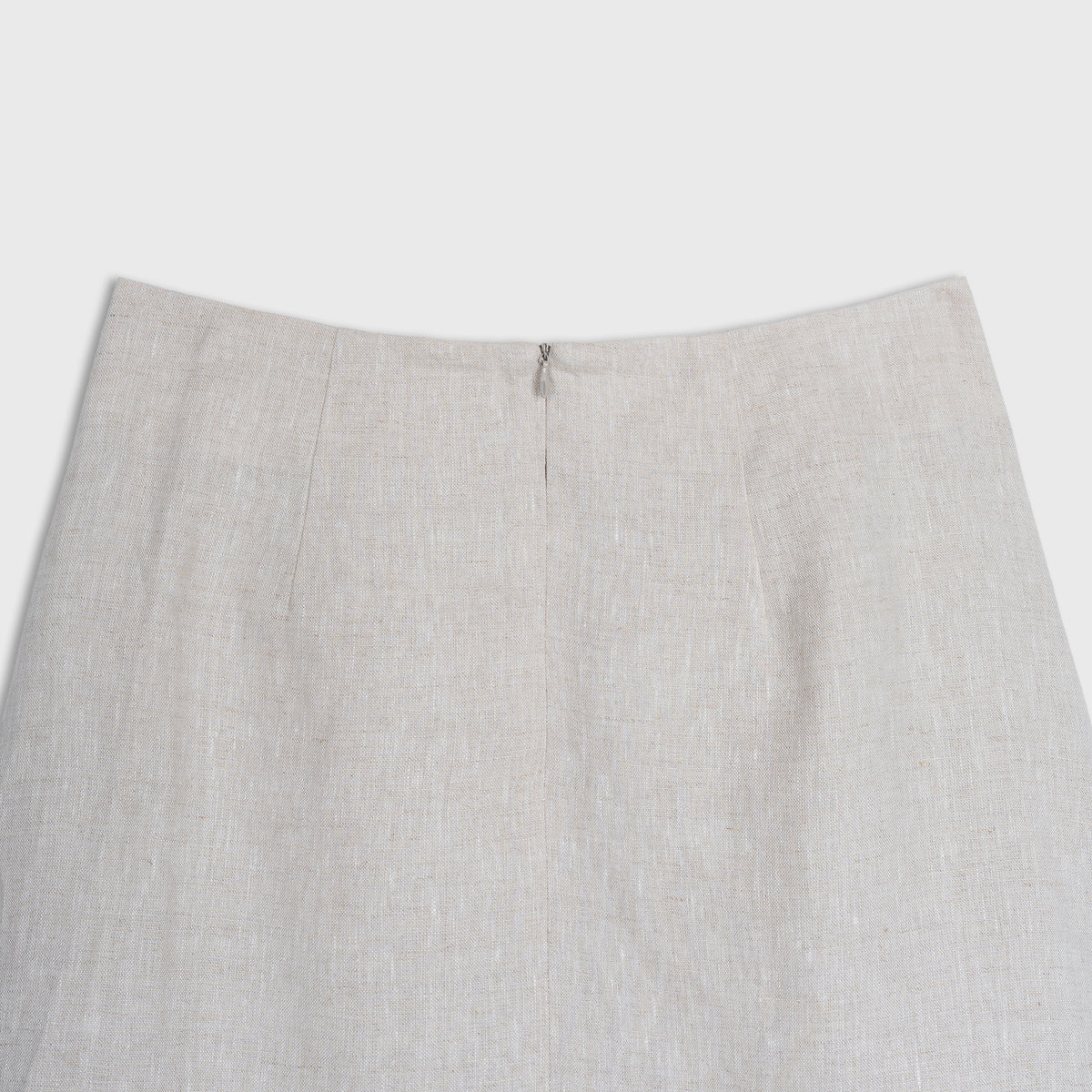 Close-up of a light beige skirt on a white background