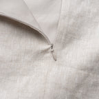 Close-up of a zipper on a light beige fabric