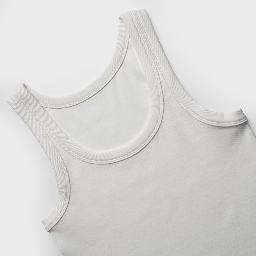 Close-up of a white tank top on a white background