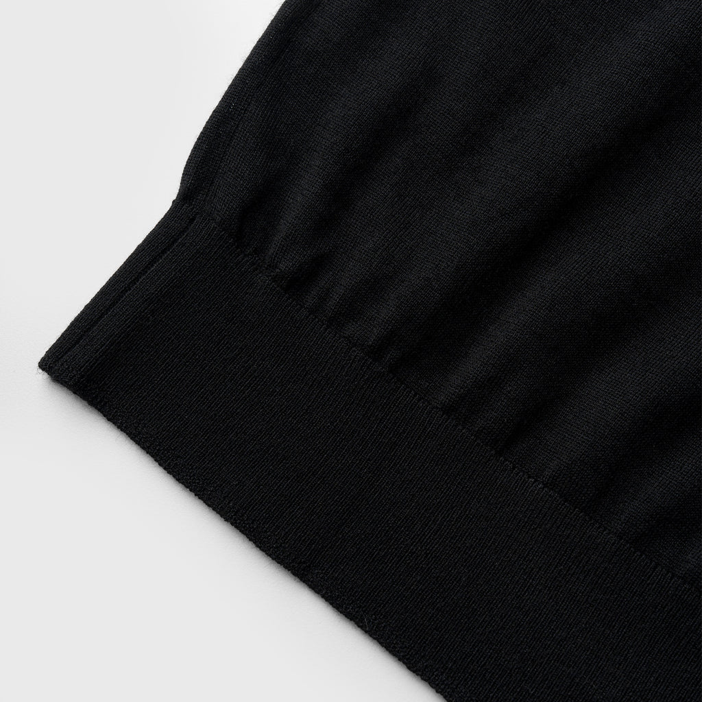 Close-up of a black fabric edge on a light gray background