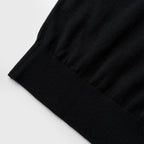 Close-up of a black fabric edge on a light gray background