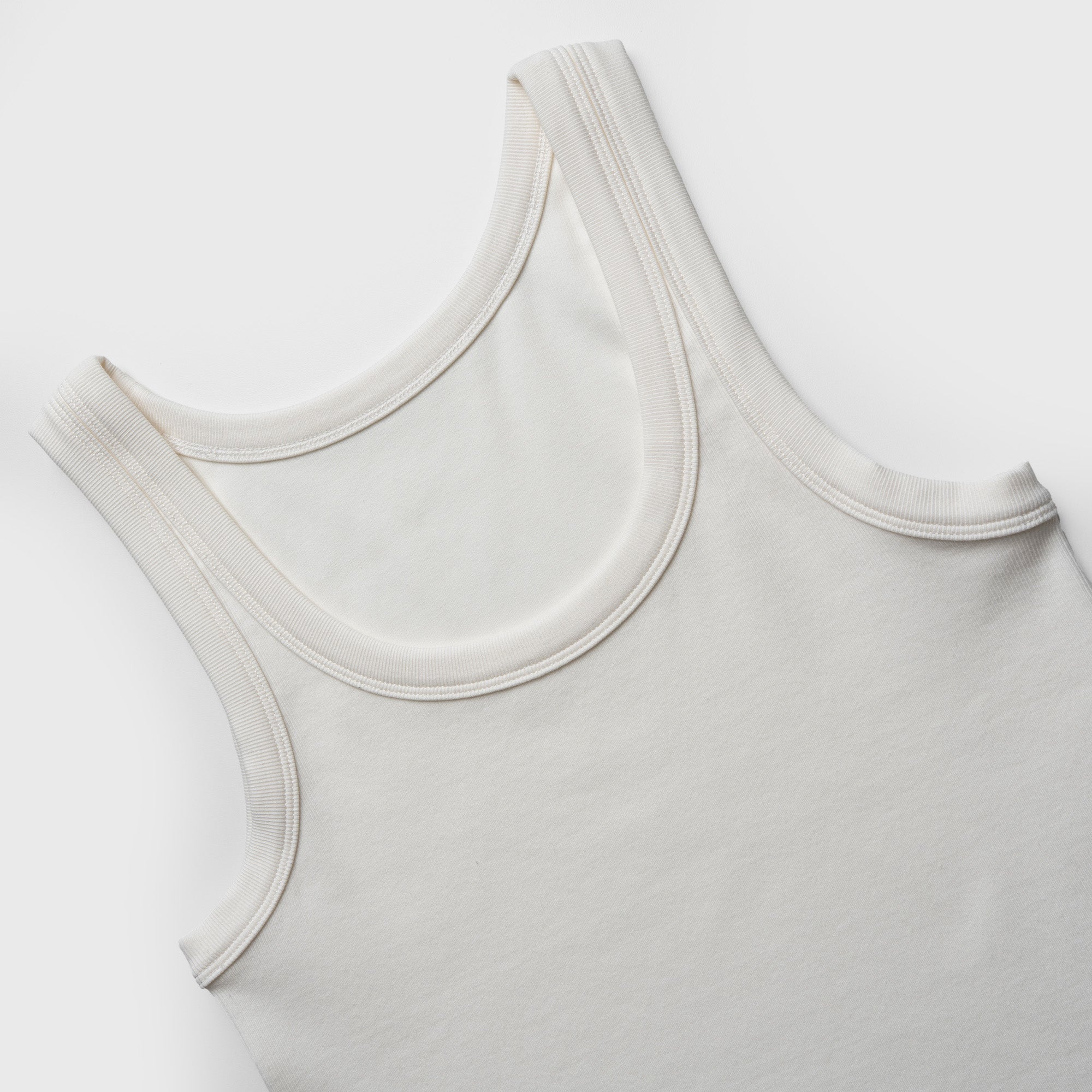 Close-up of a white tank top on a white background