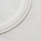 Close-up of a white fabric texture with a circular pattern