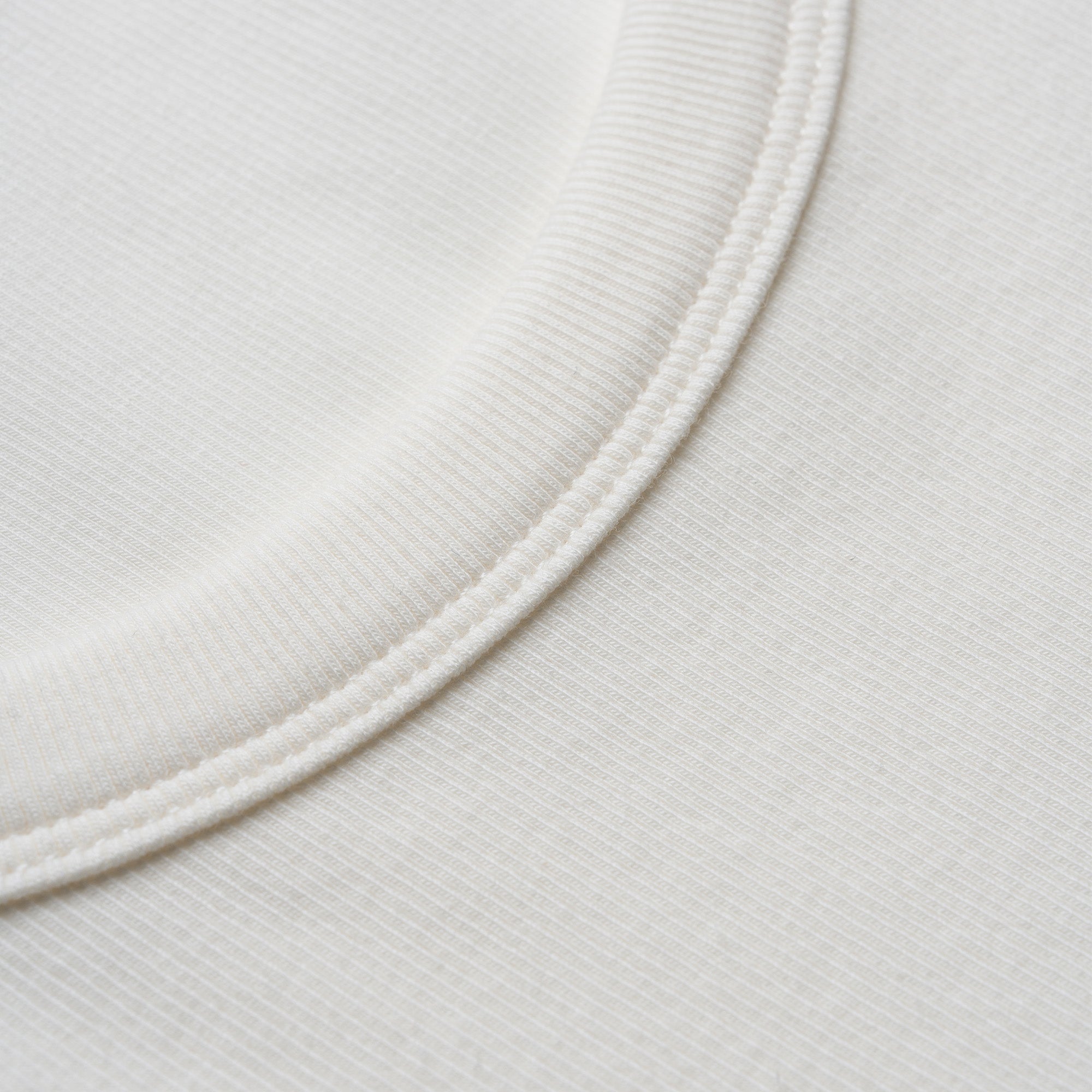 Close-up of a white fabric texture with a circular pattern