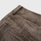 Close-up of brown fabric pant on a light gray background
