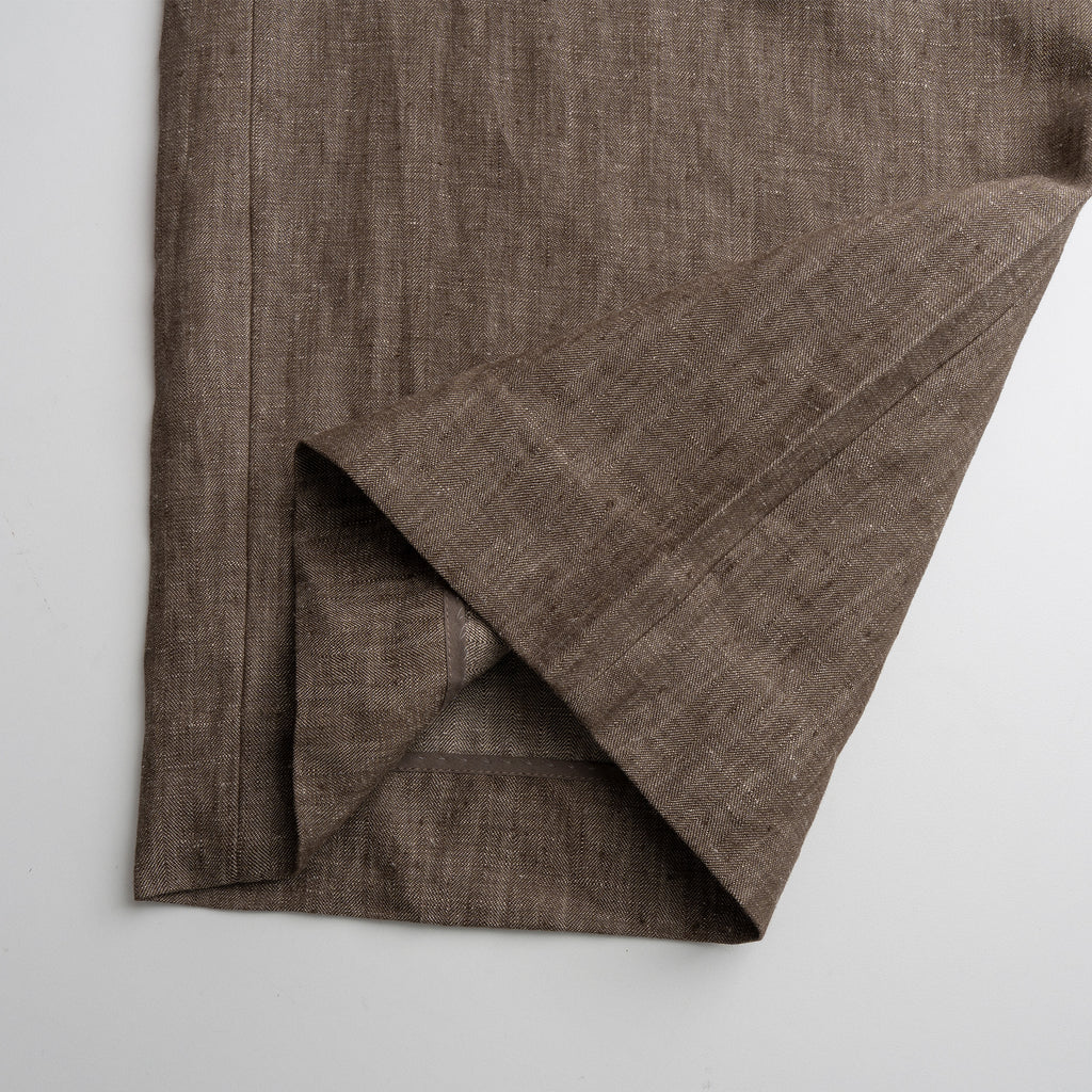 Brown fabric folded Pant on a light gray background