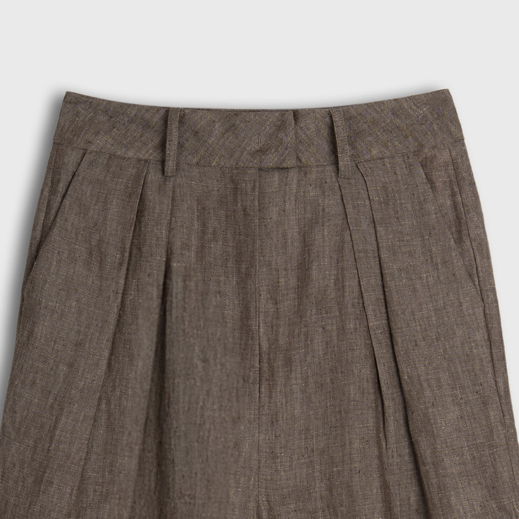 Brown pleated pants on a light gray background