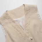 Beige vest with intricate embroidery on a white background