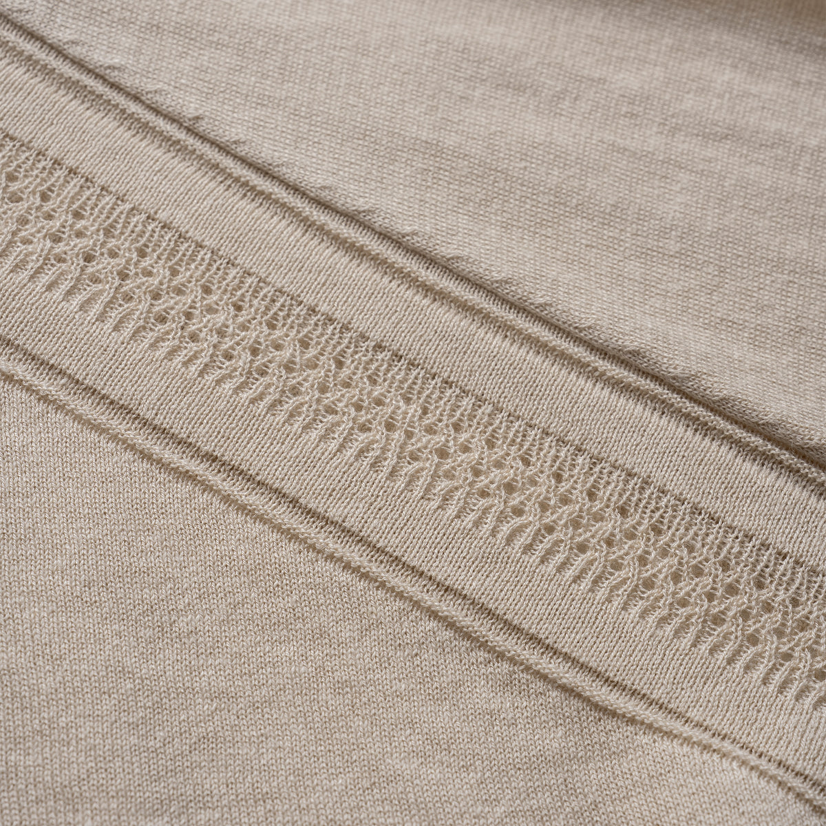 Close-up of beige fabric with lace trim detail