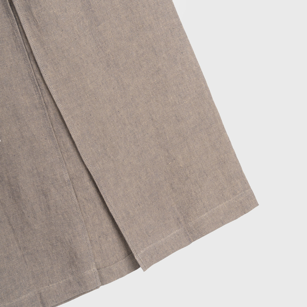Close-up of a brown hemp skirt piece on a light gray background