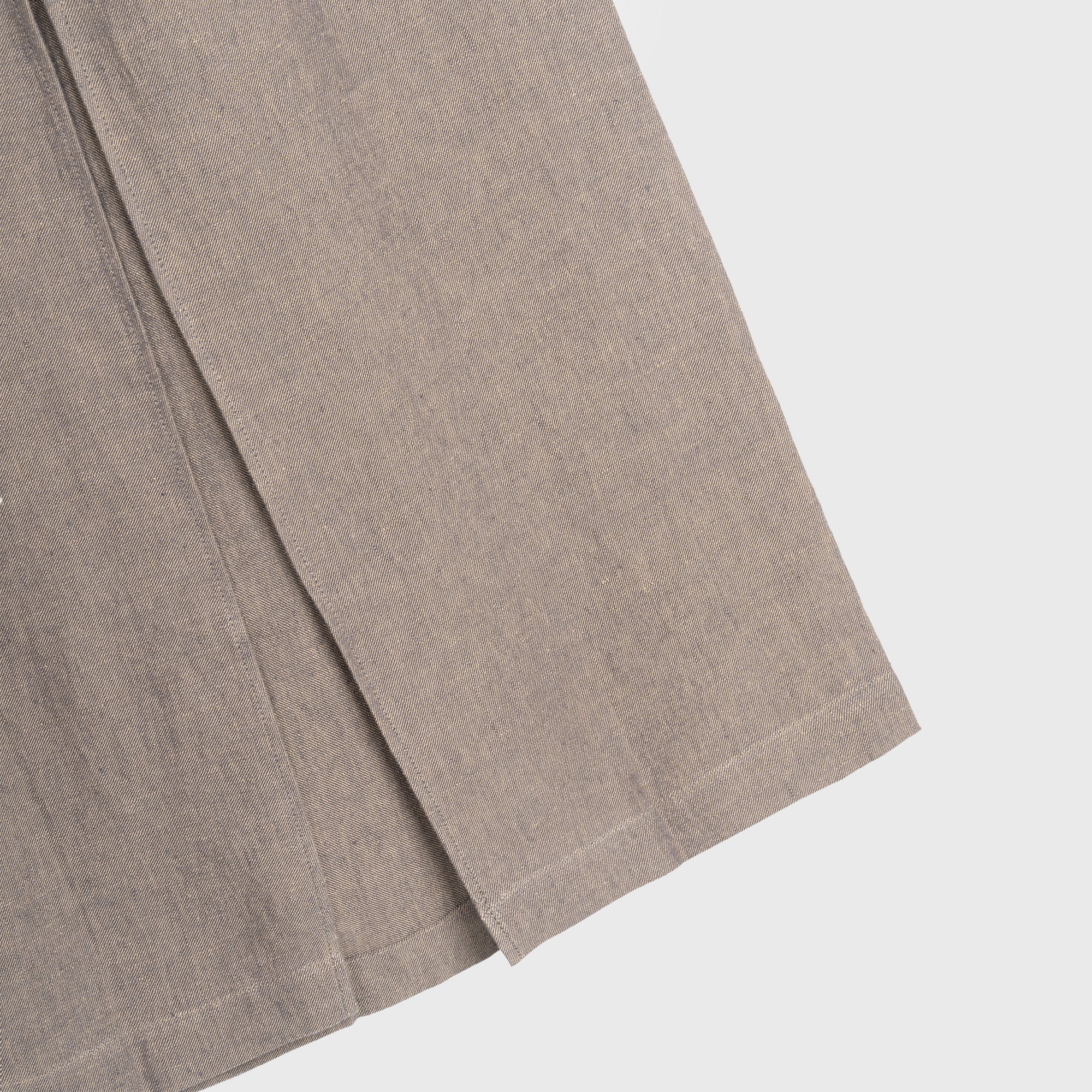 Close-up of a brown hemp skirt piece on a light gray background