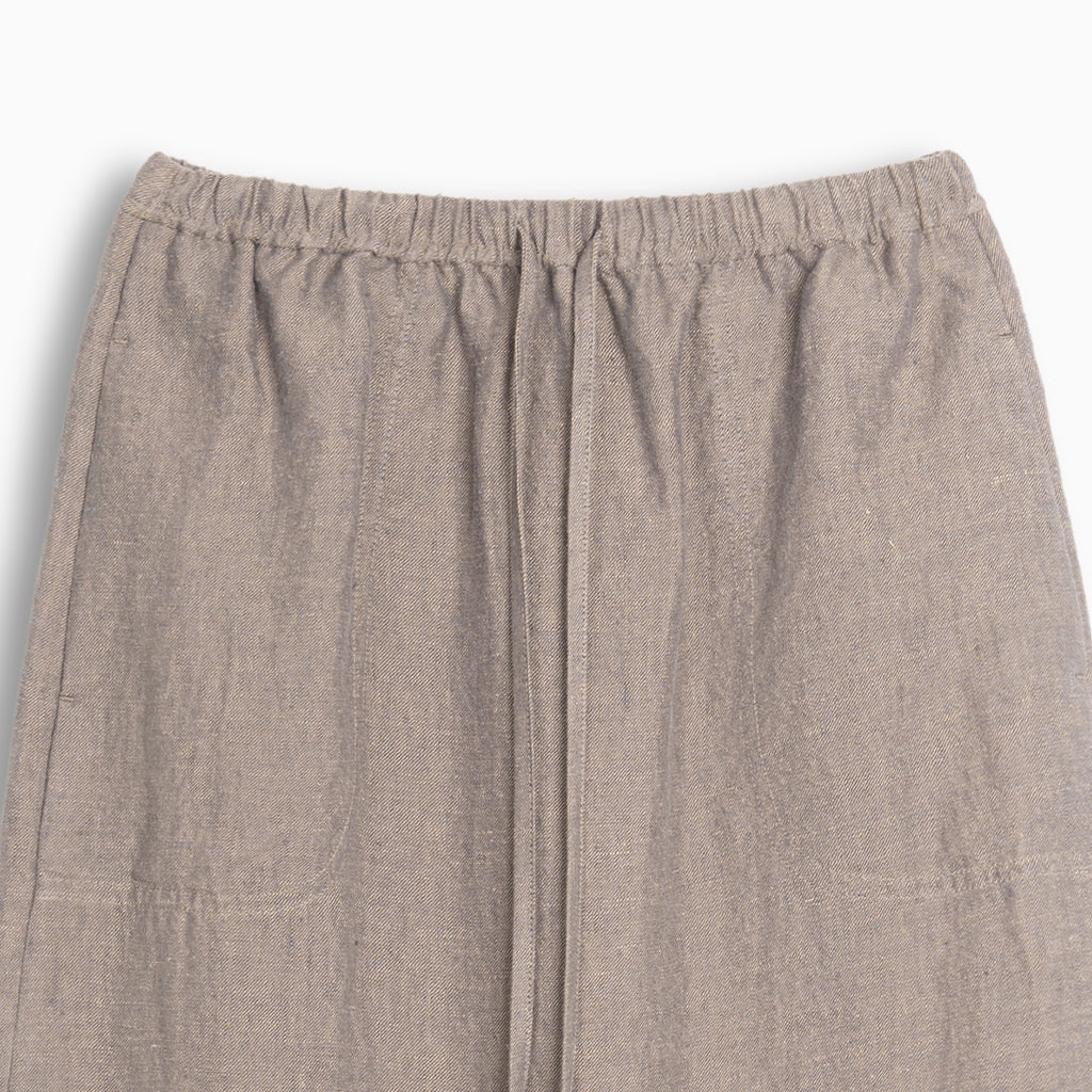 Close-up of beige hemp skirt with an elastic waistband on a white background