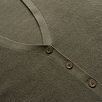 Close-up of a green garment with button details