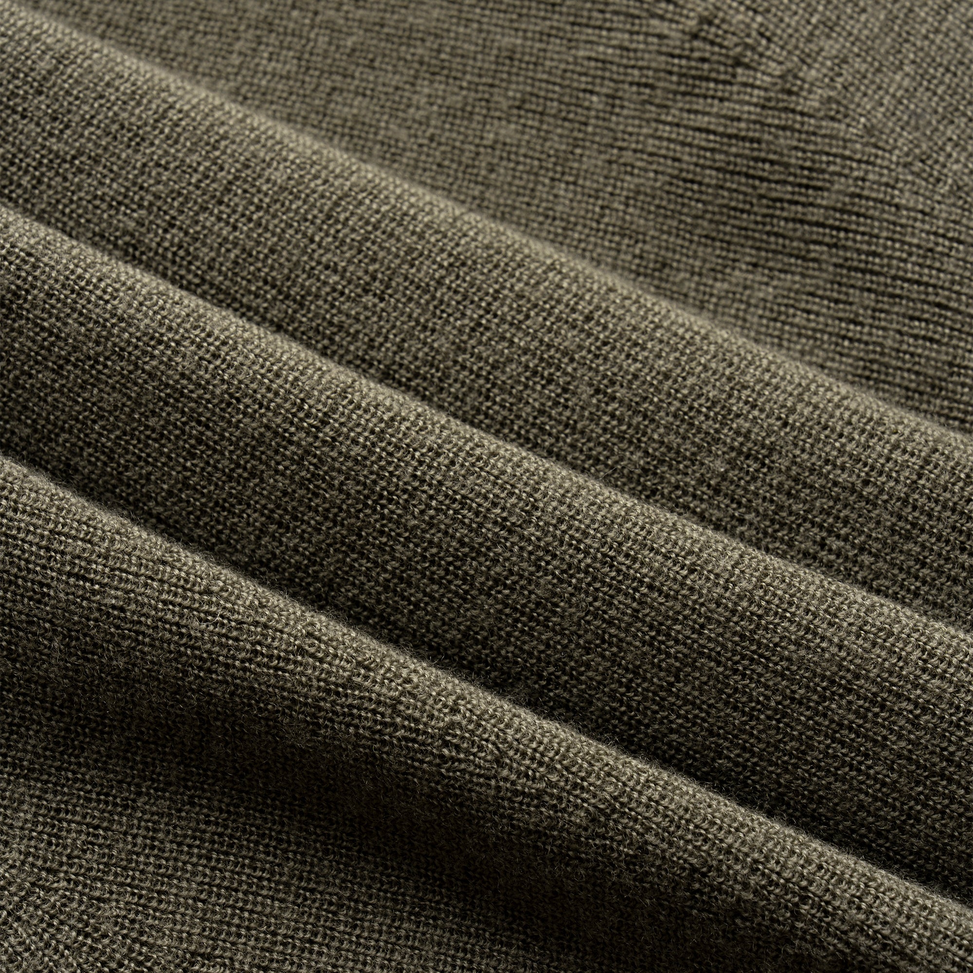 Close-up of olive green fabric with visible texture