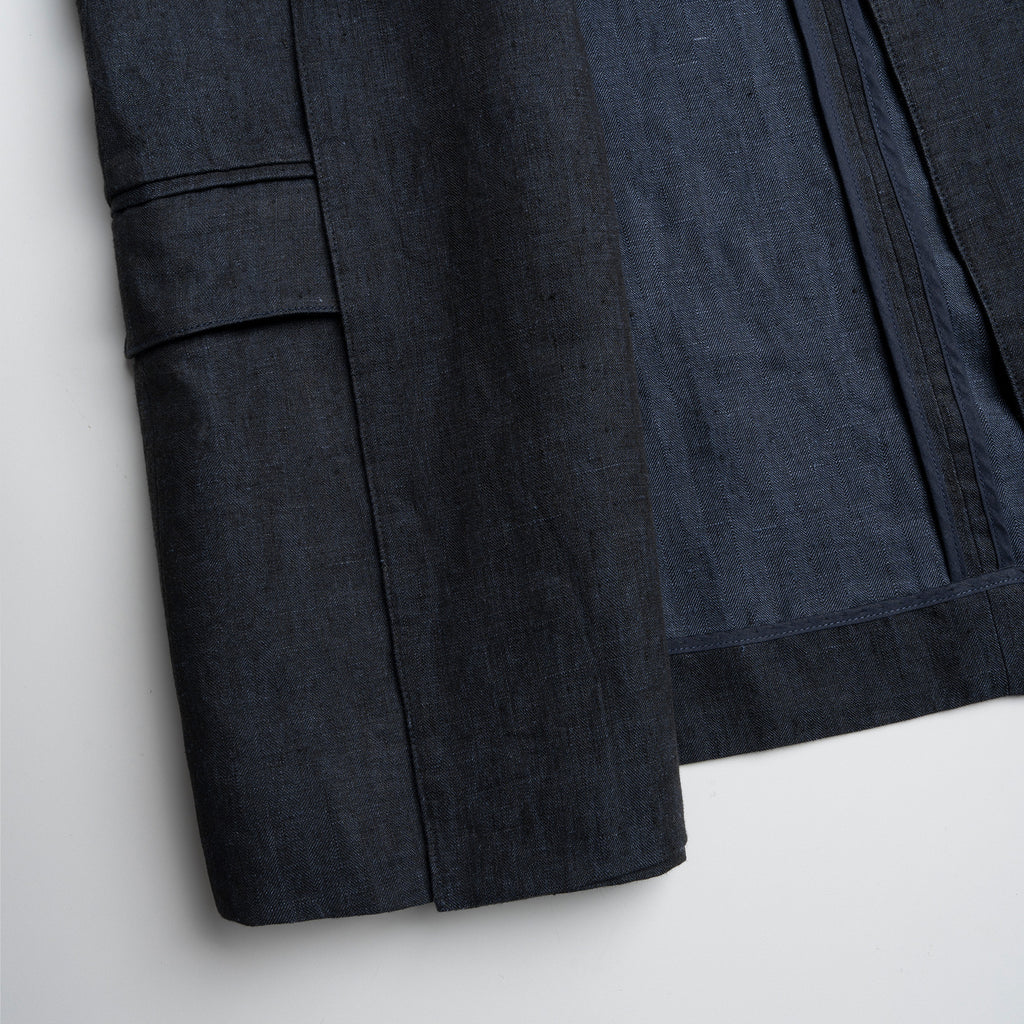 Dark blue fabric with a pocket detail on a light gray background