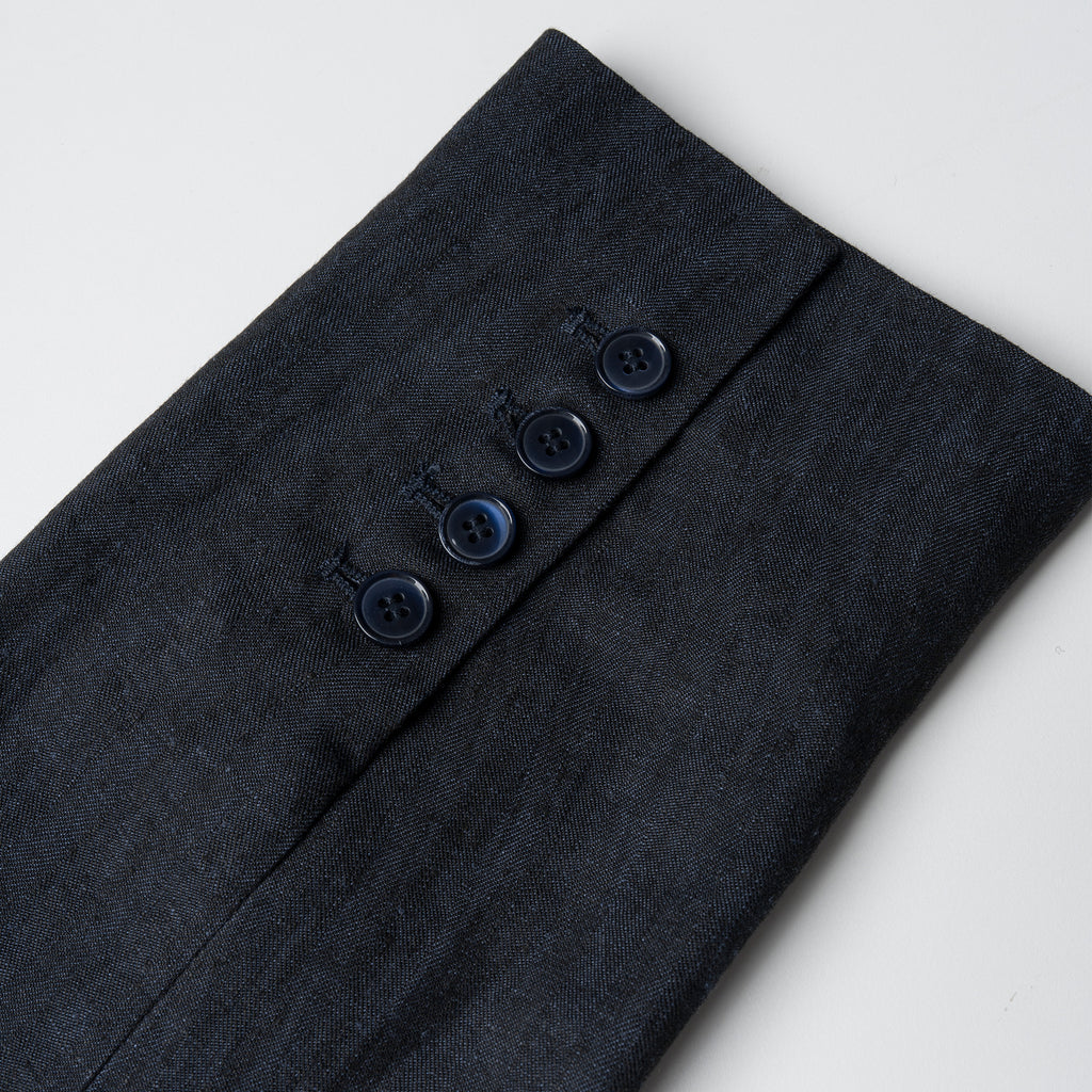 Navy linen fabric with buttons on a light gray background