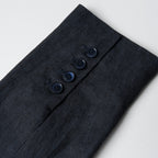 Navy linen fabric with buttons on a light gray background