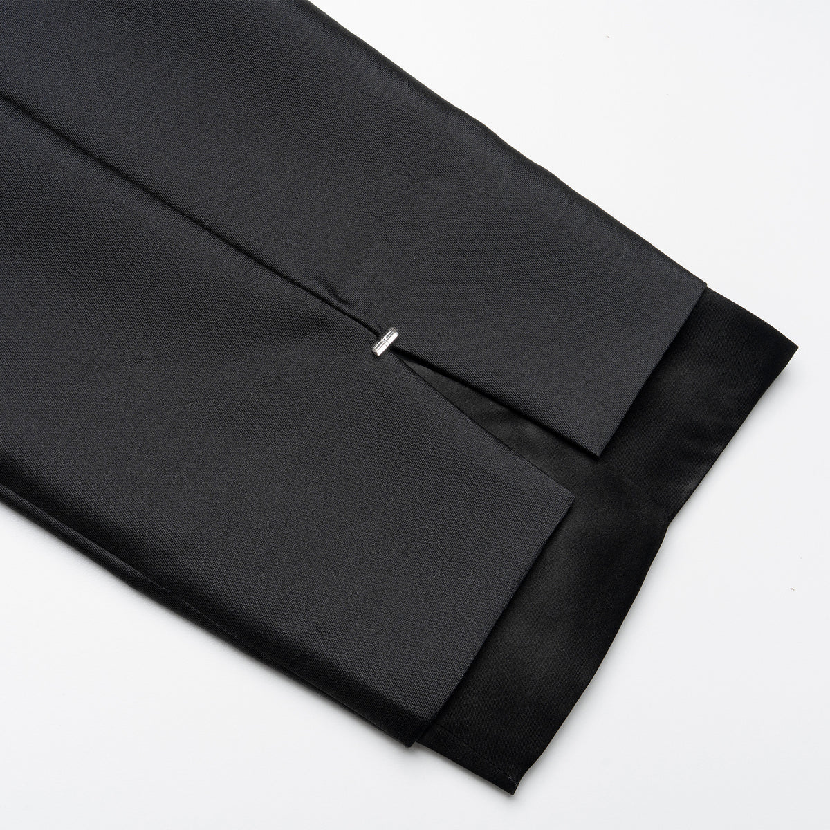 Black fabric with a pleated design on a white background