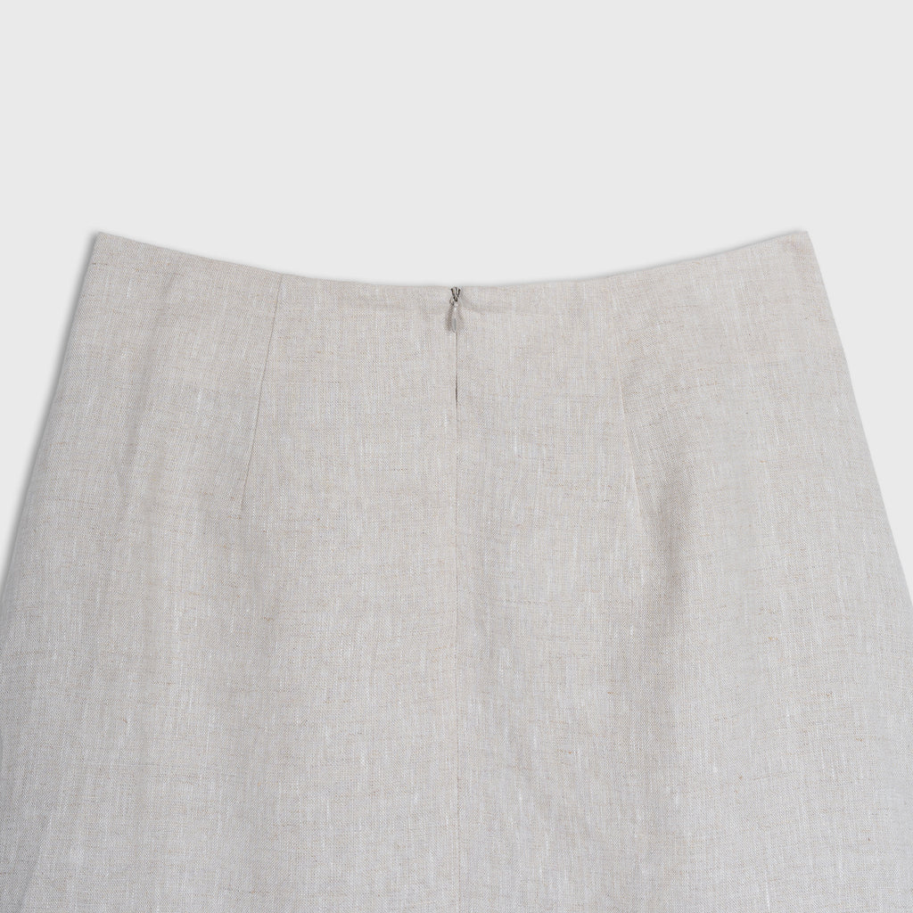 Close-up of a light beige skirt on a white background