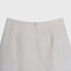 Close-up of a light beige skirt on a white background