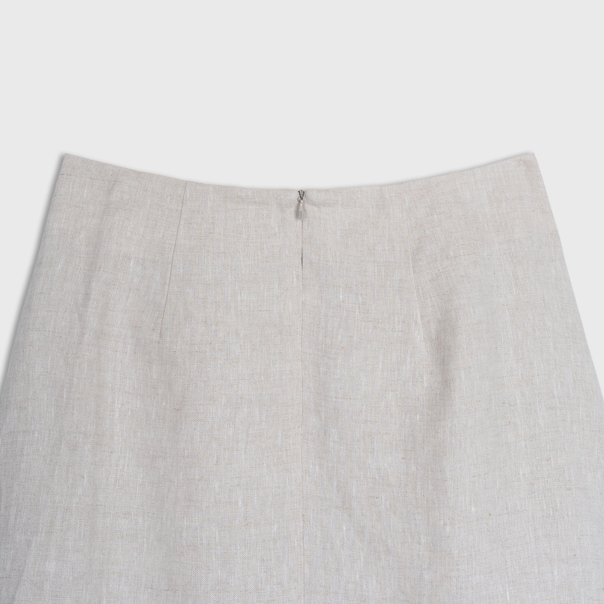 Close-up of a light beige skirt on a white background