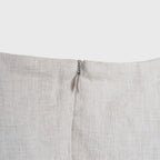 Close-up of a light beige fabric with a zipper on a white background