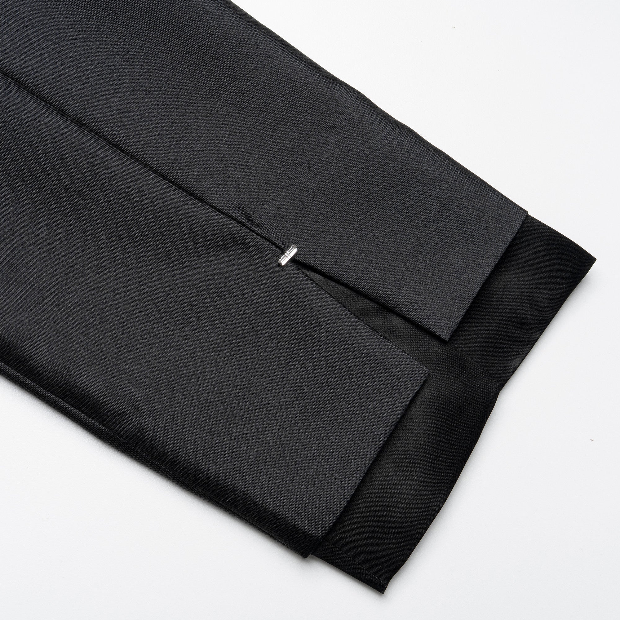 Black fabric with a pleated design on a white background