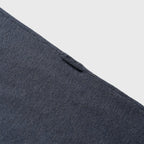 Close-up of a blue denim shirt with buttons on a light gray background