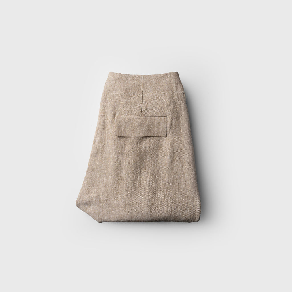 Folded beige skirt on a light gray background