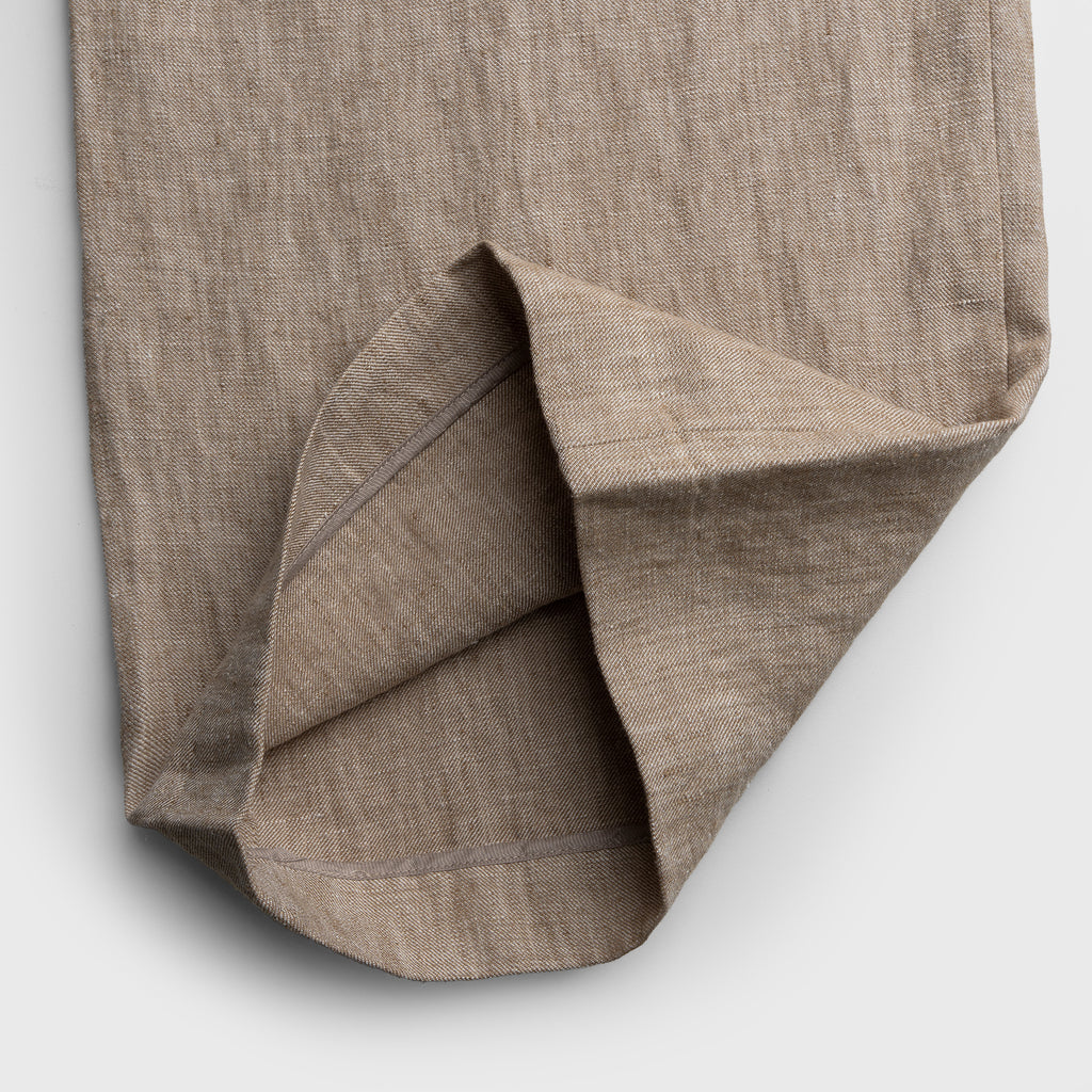 Close-up of a brown fabric with a textured pattern on a white background