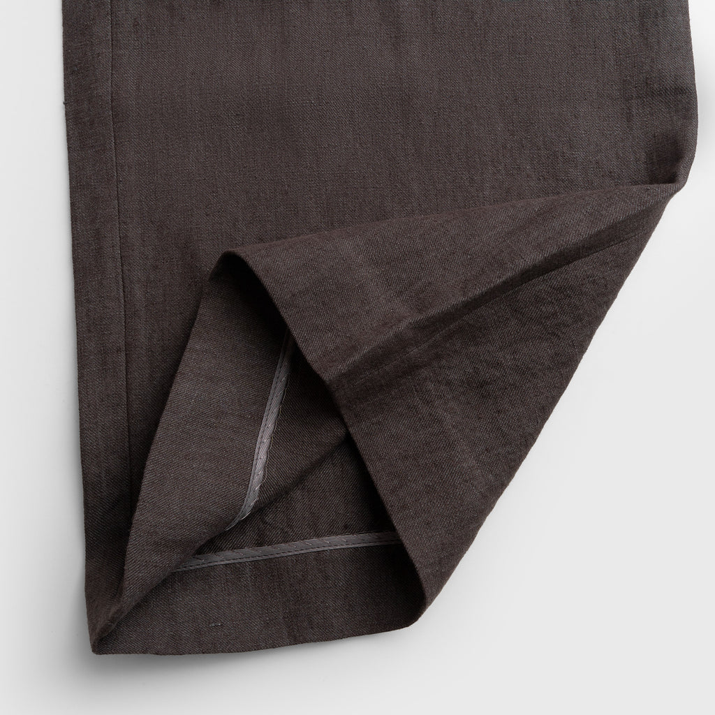 Dark brown fabric folded on a light gray background