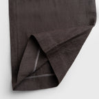 Dark brown fabric folded on a light gray background