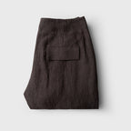 Folded dark brown pants on a light gray background