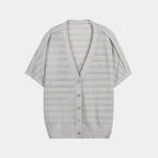 Gray cardigan with button details on a white background