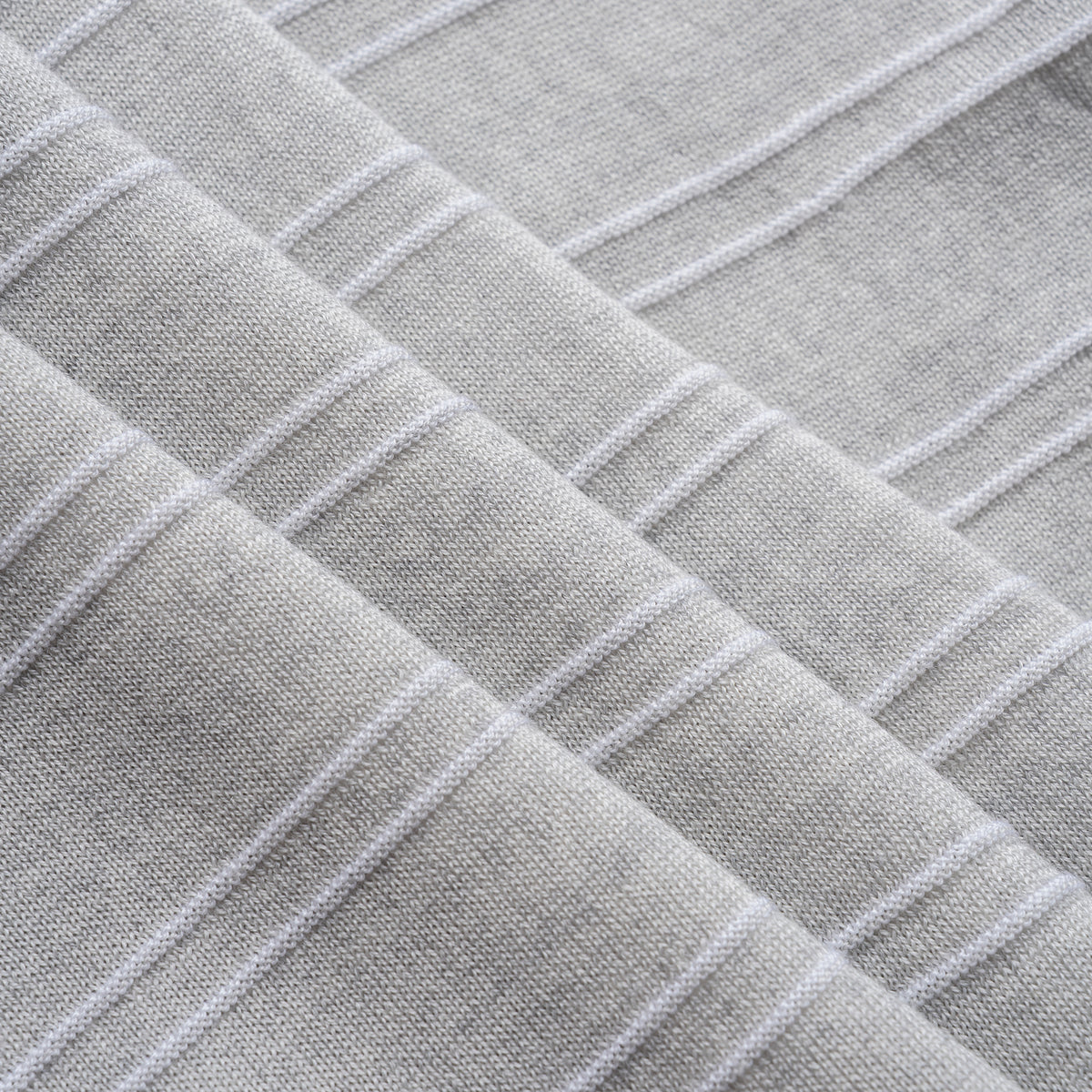 Close-up of textured gray fabric with a diamond pattern