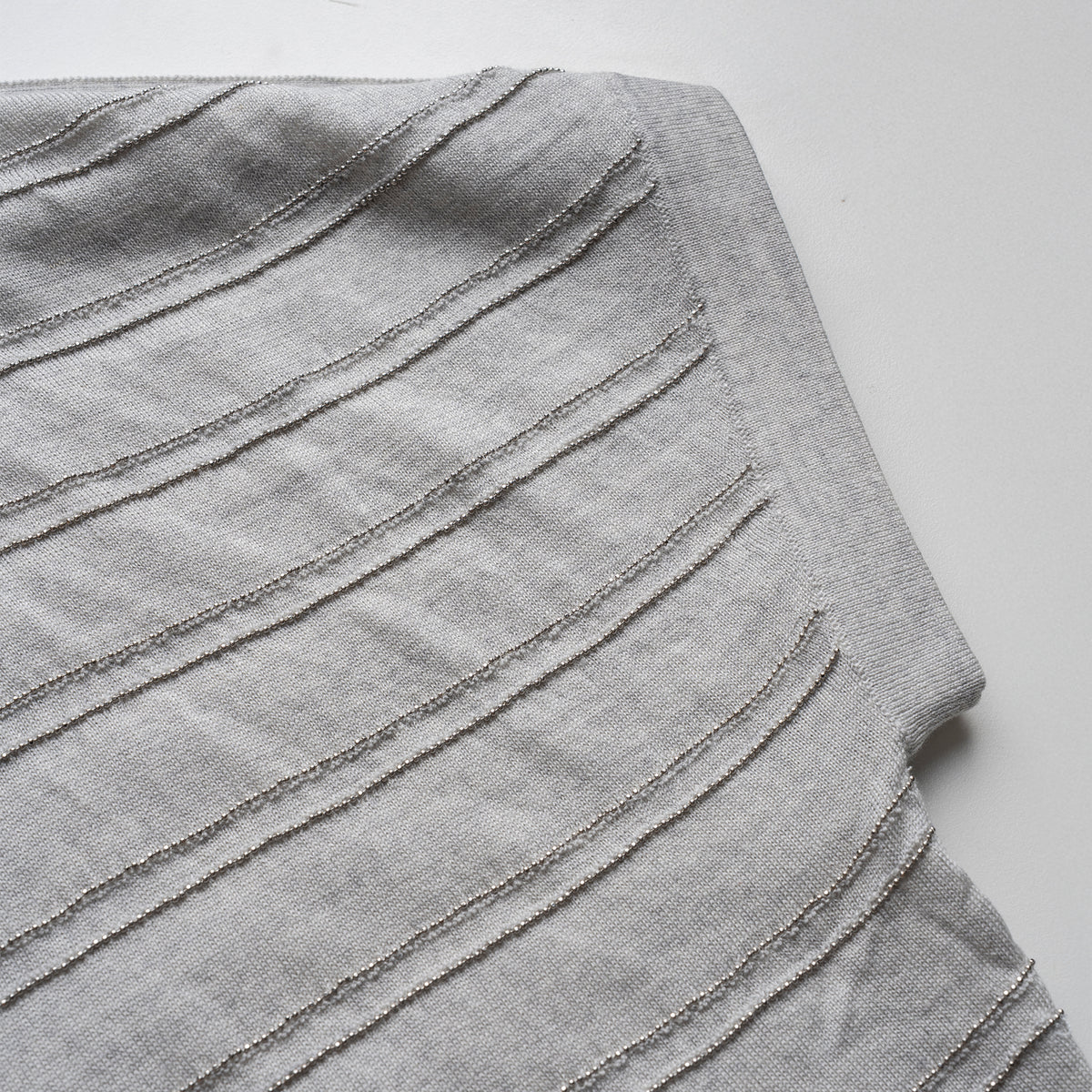 Gray pleated cardigan on a white background