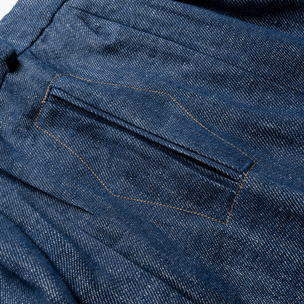 Close-up of blue denim fabric with stitching detail