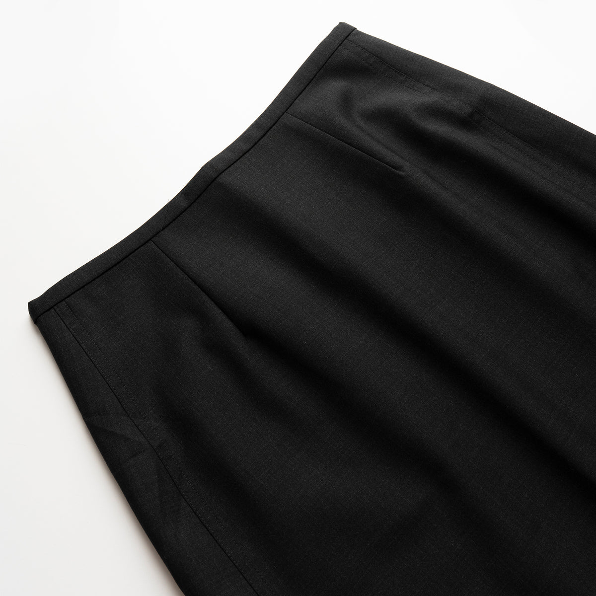 Close-up of a black wool skirt on a white background