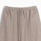 Close-up of beige hemp skirt with an elastic waistband on a white background
