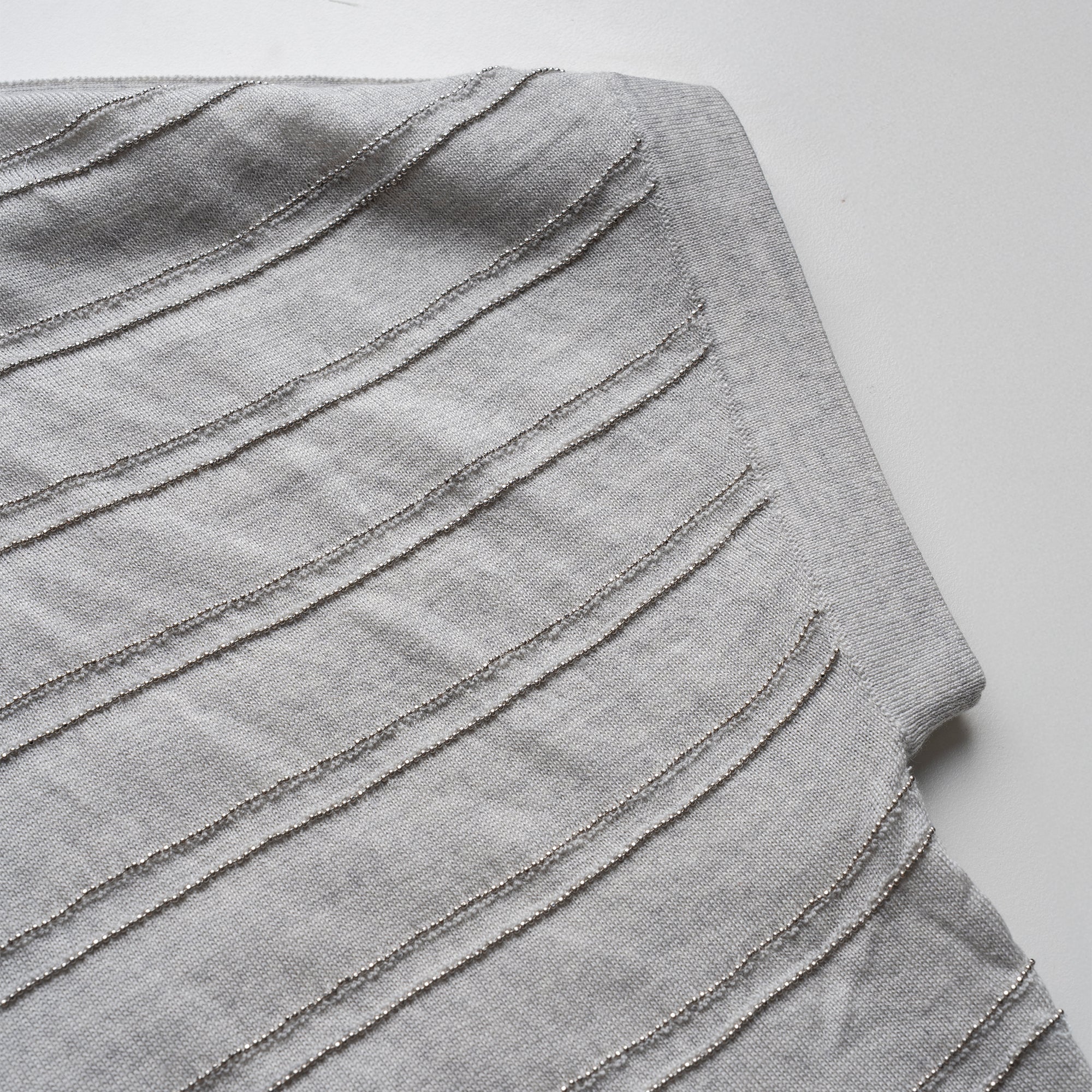 Gray pleated cardigan on a white background