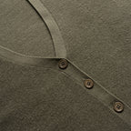 Close-up of a green garment with button details