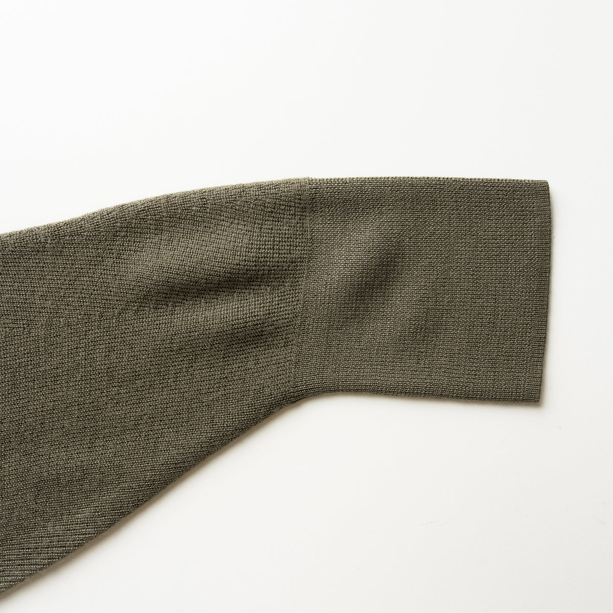 Close-up of a olive green  sleeve on a white background